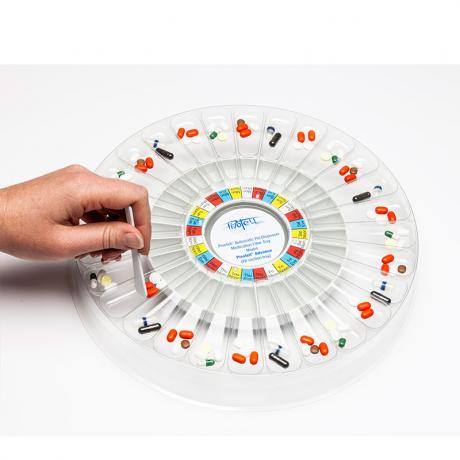  Filler Tray on the Advance Dispenser with medication being pushed into dispenser tray.