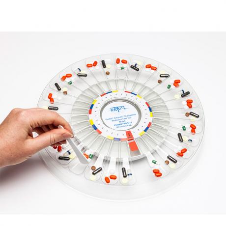  Filler Tray on the Mk3 Dispenser with medication being pushed into dispenser tray.